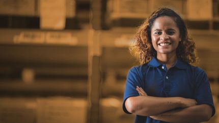 Woman smiling in warehouse