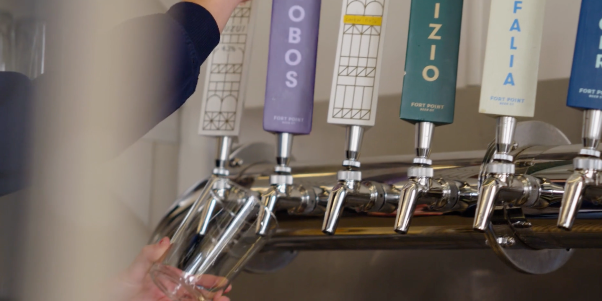 Photo of person pouring beer from tap at Fort Point Beer Co