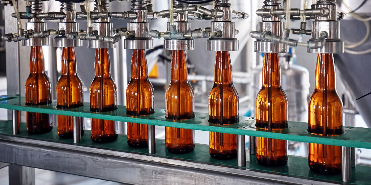 A row of beer bottles on a filling line