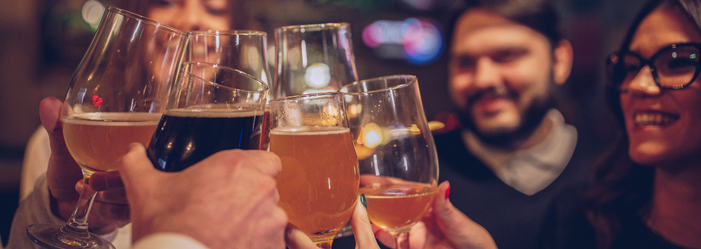 A group of people are toasting with wine glasses at a party.