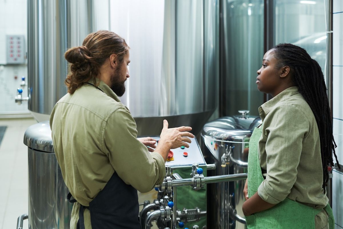 Head brewer training a team member on how to make cider