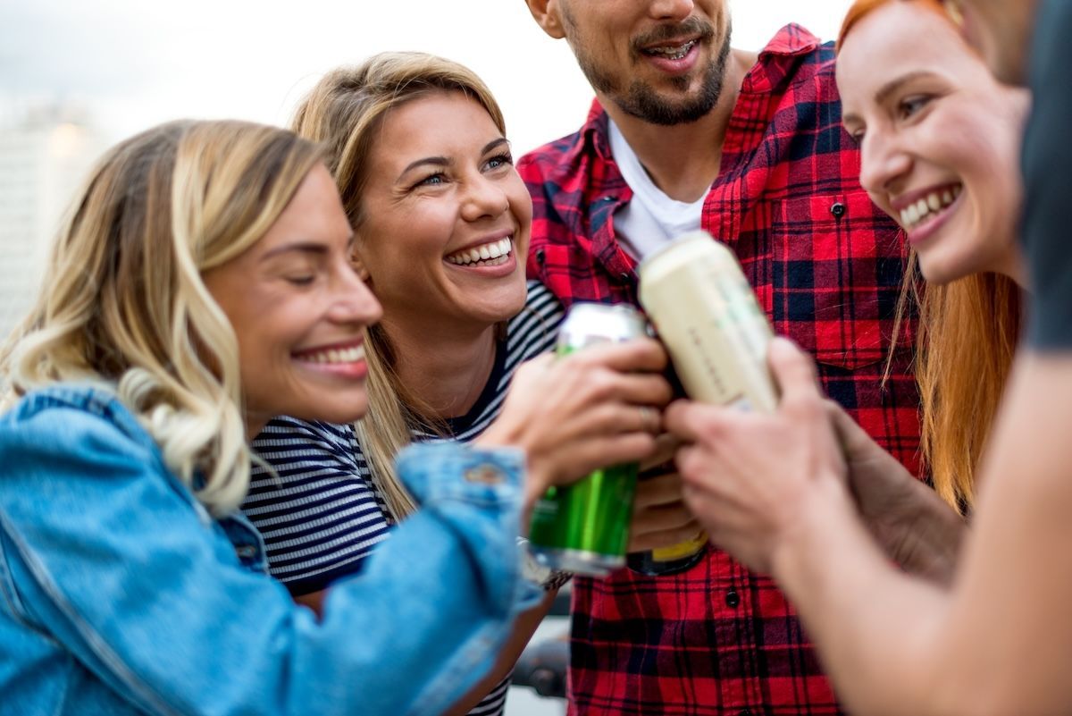 Group of friends enjoying canned ready-to-drink beverages 