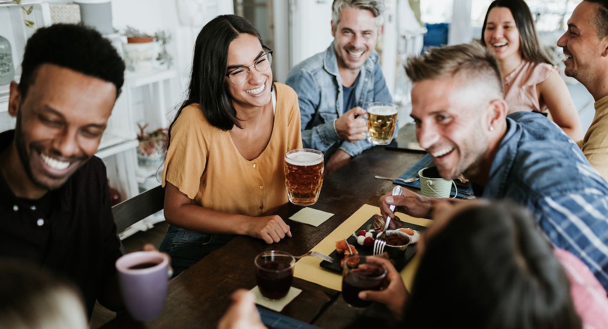 Group of friends drinking coffee and beer