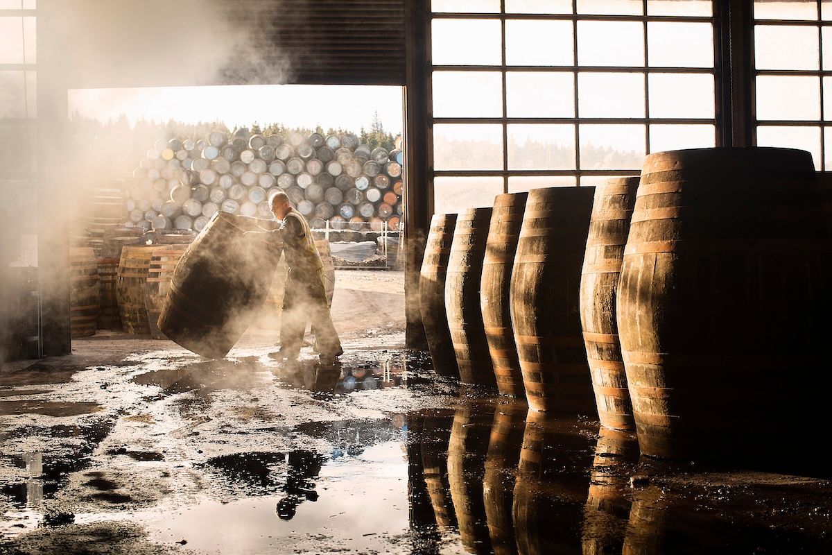 Male distillery employee working in cooperage