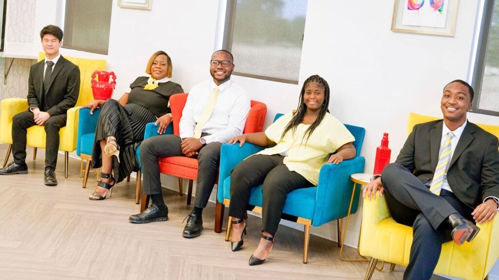 A group of people are sitting in chairs in a waiting room.