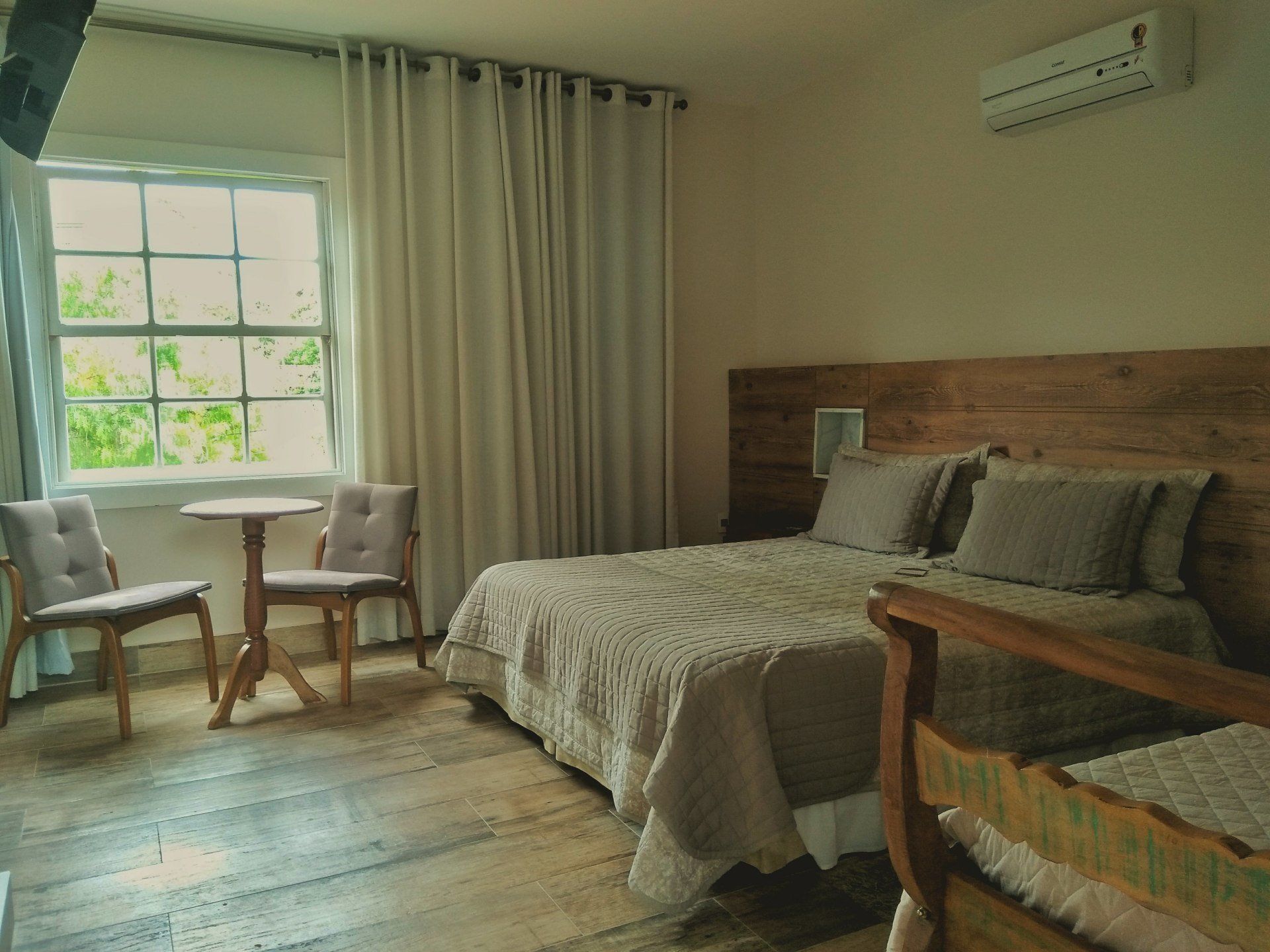 Um quarto de hotel com duas camas, uma mesa e cadeiras