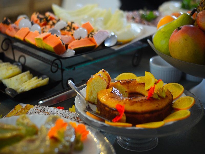 Há um bolo em um prato com frutas nele.