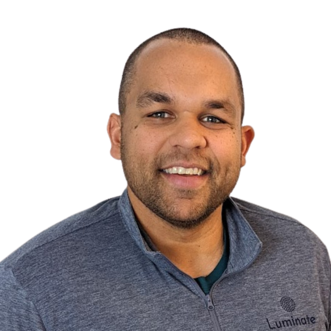 Smiling man in a gray zip-up jacket against a white background