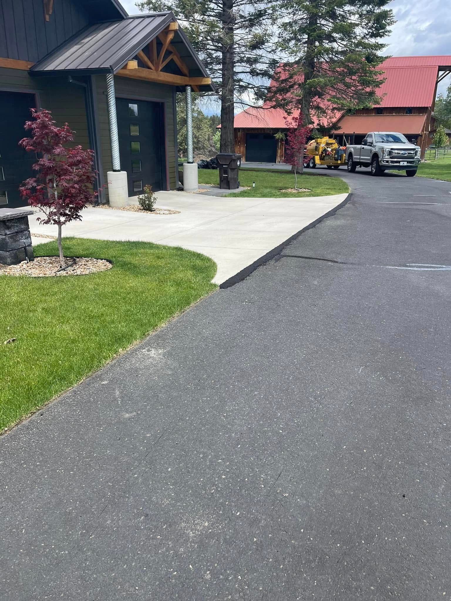 A truck is parked on the side of the road in front of a house.
