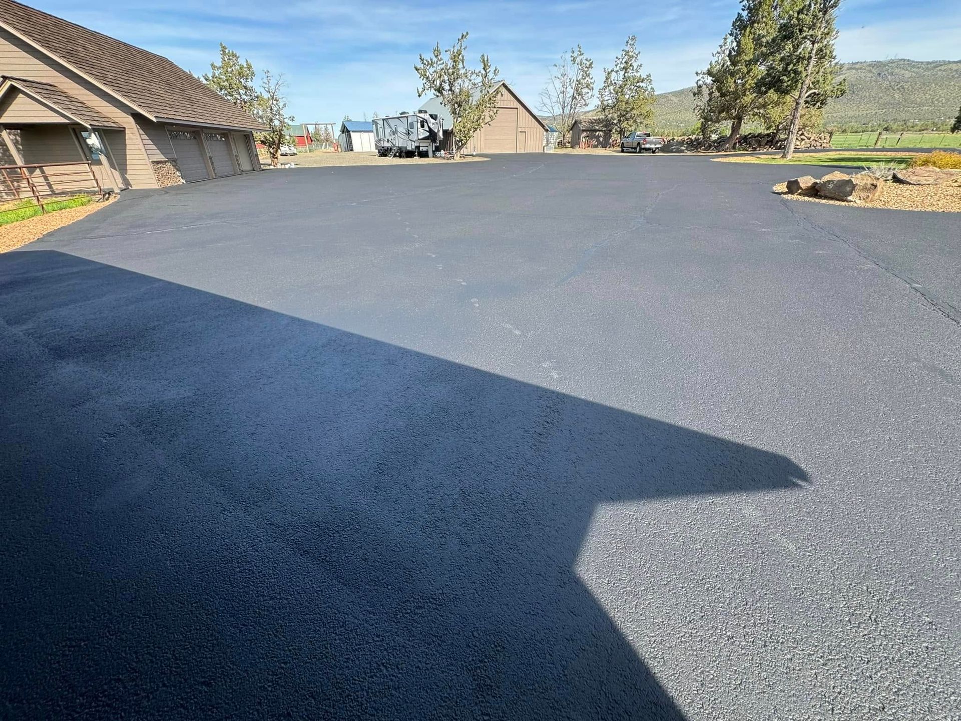 A car is parked in a driveway next to a house.