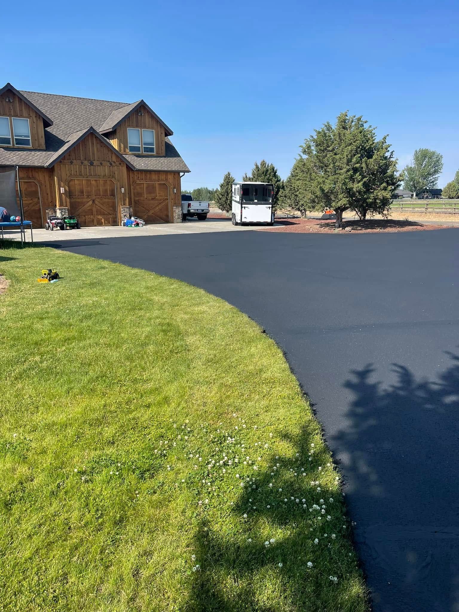 A large house with a large driveway in front of it.