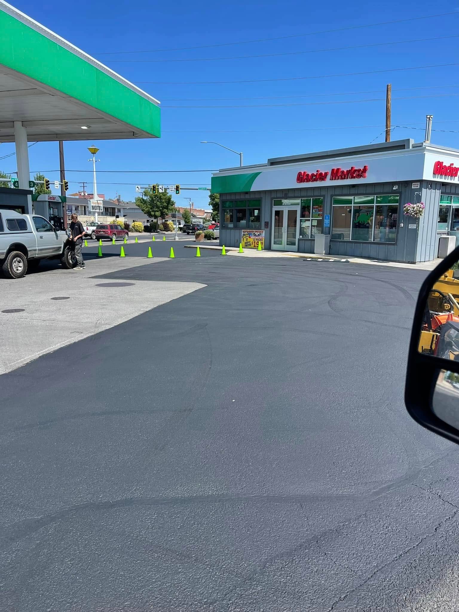 A car is parked in front of a gas station.