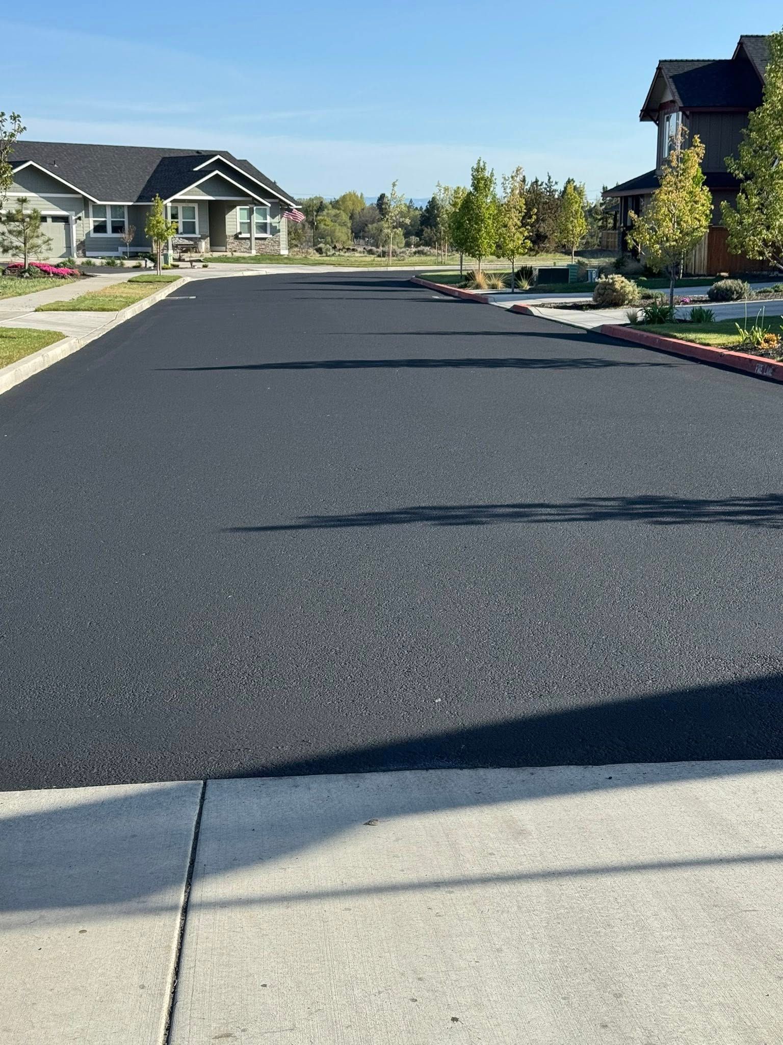 A row of houses are lined up on the side of a road.
