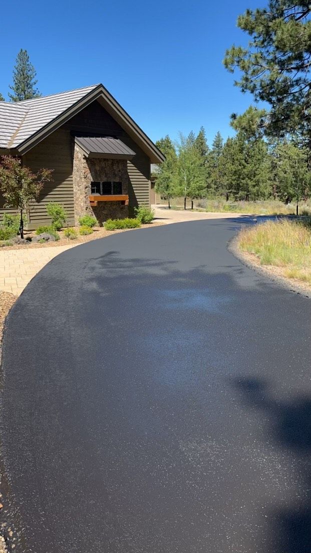 A house is sitting on the side of a road next to a house.