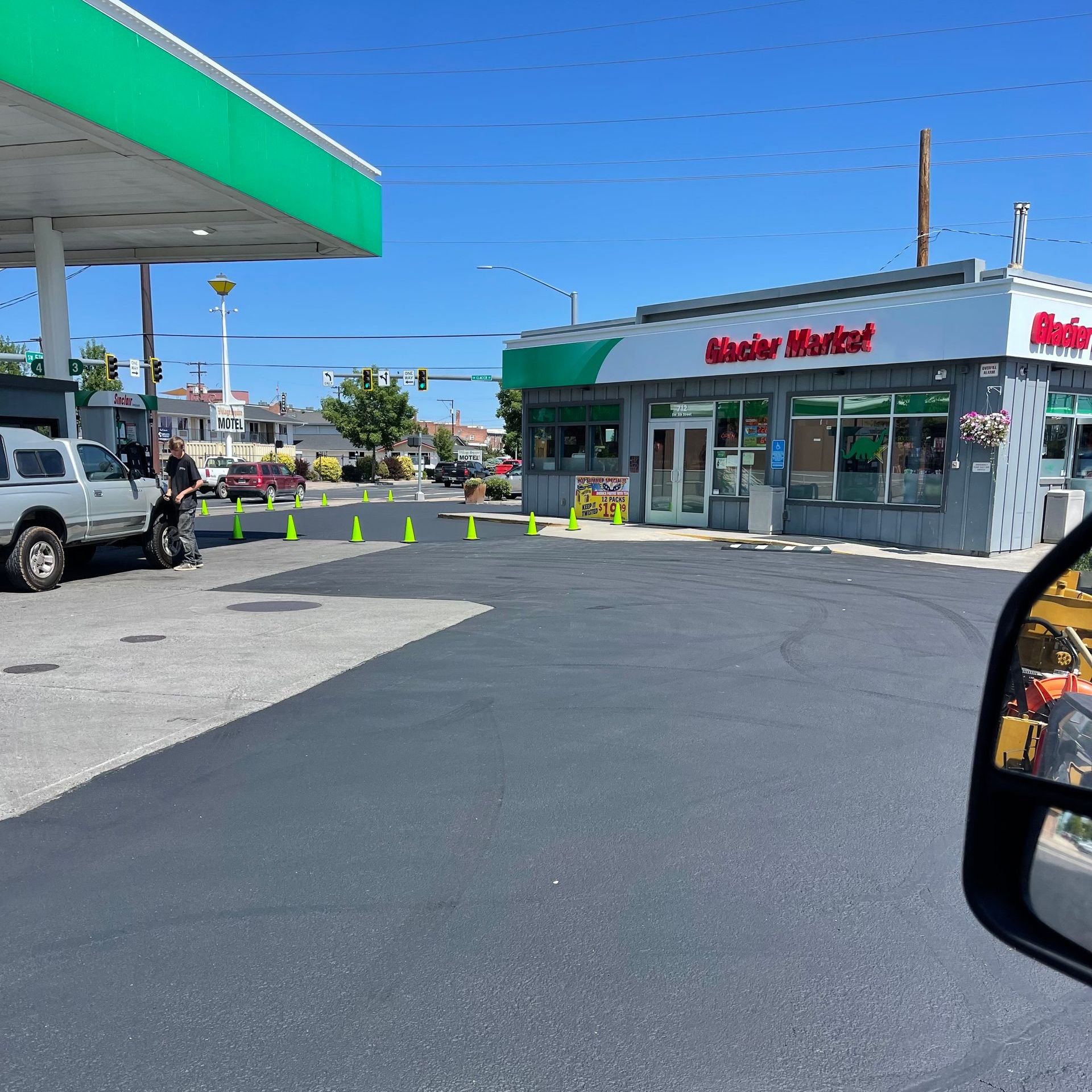 A view of a gas station from a rear view mirror