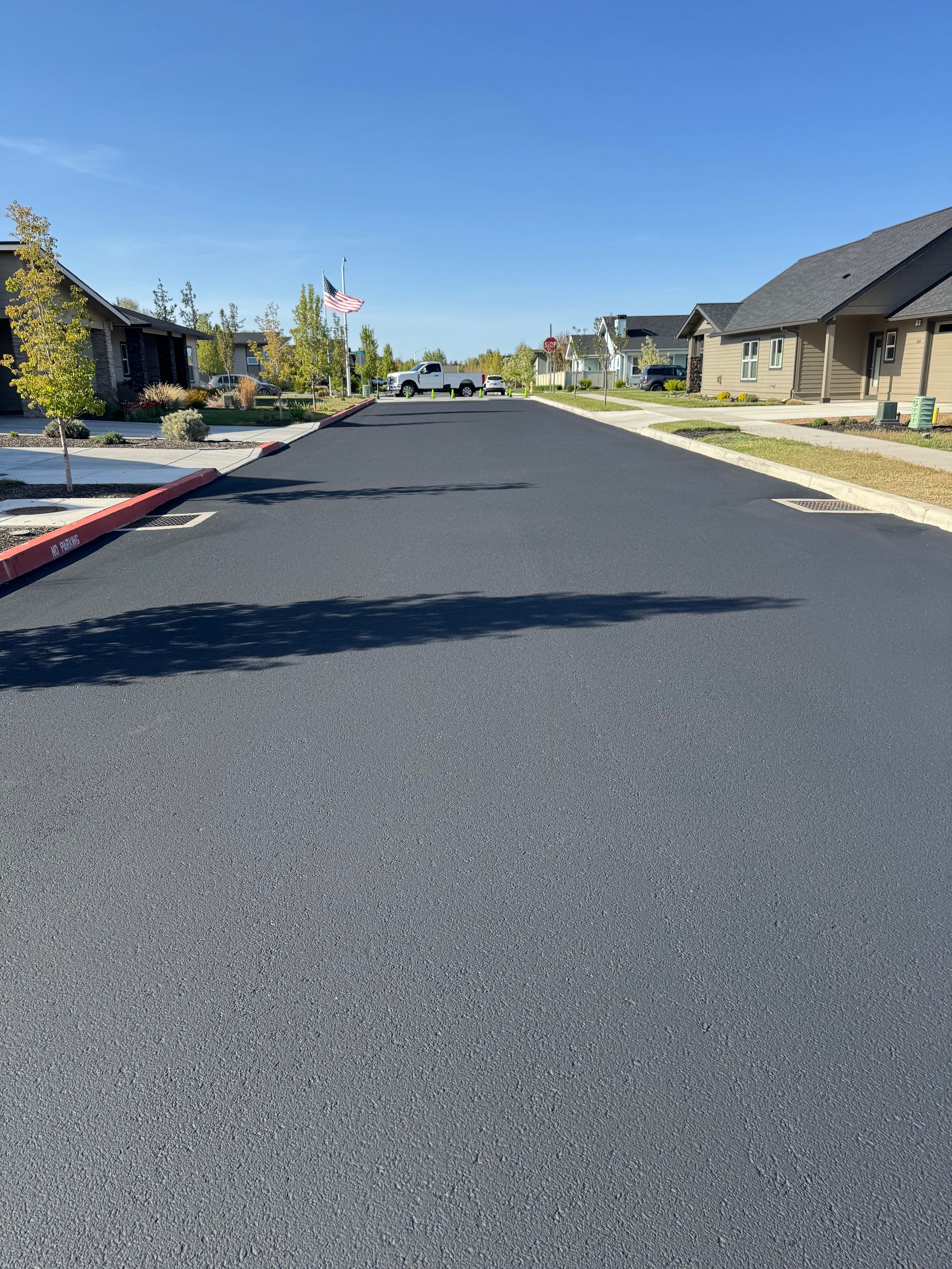 A residential street with a flag on the side of it.