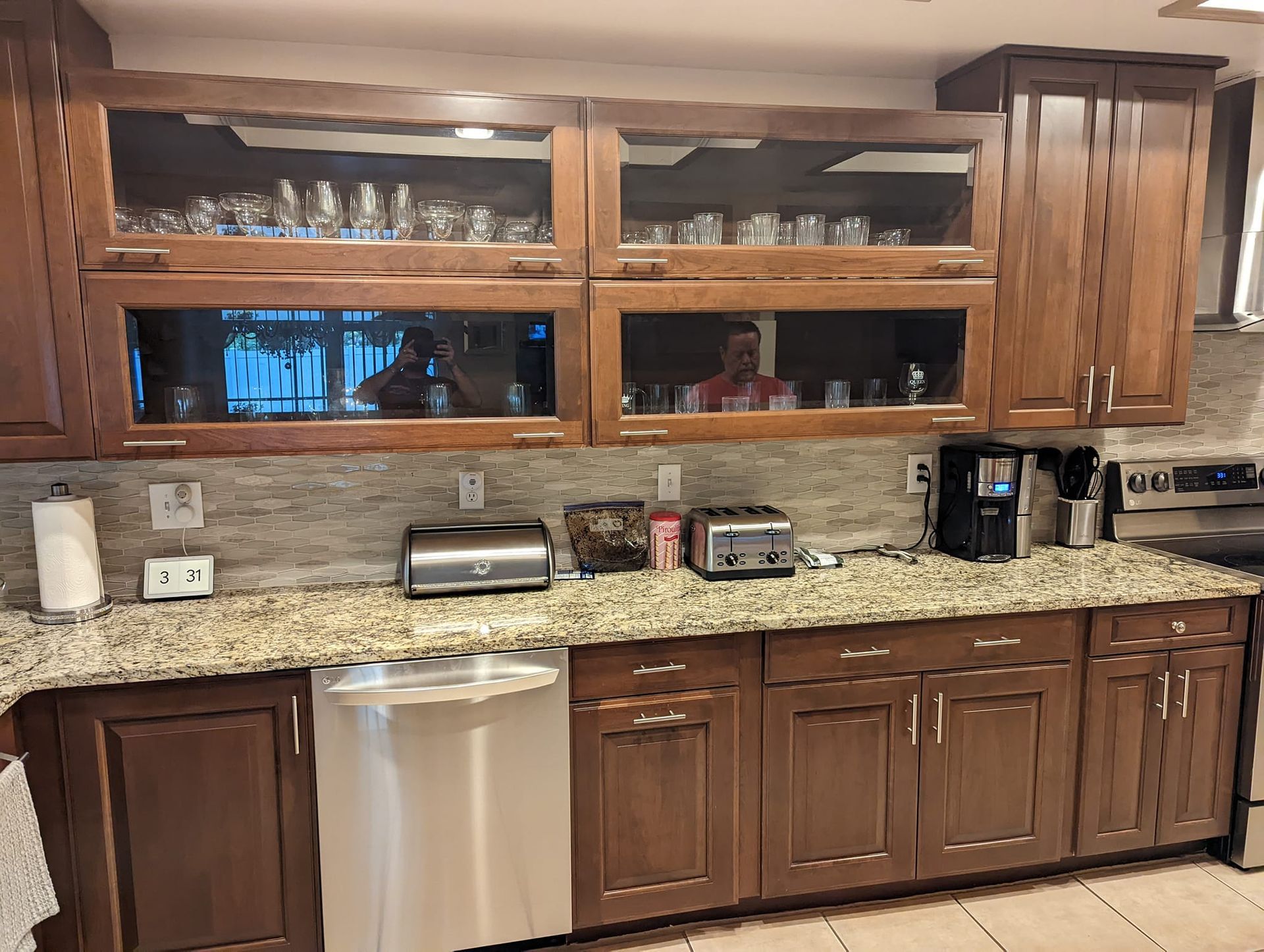 Kitchen with brown cabinets, granite countertops, and stainless steel appliances.
