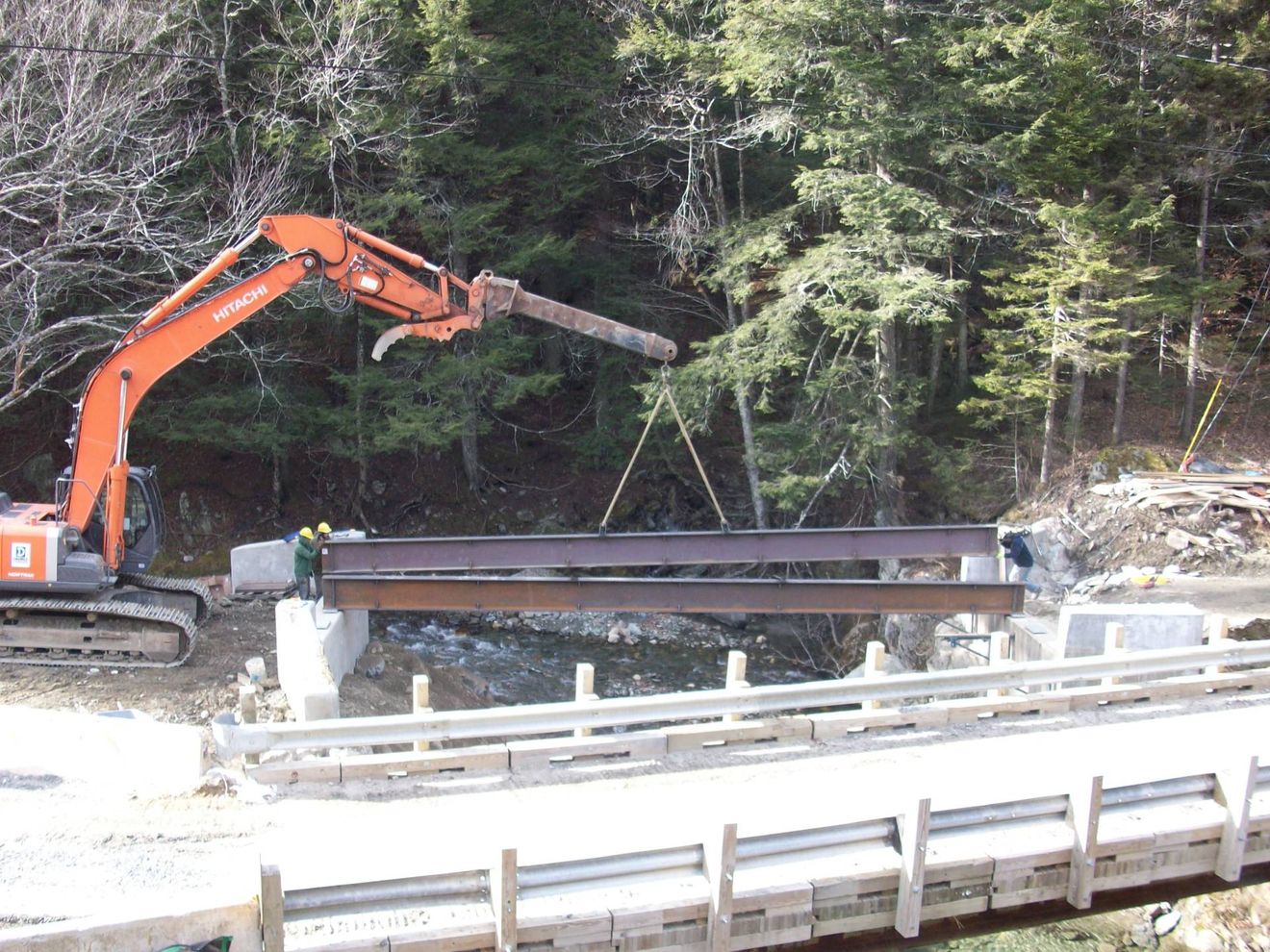 Installation of a 75 foot long temporary bridge, construction of a new reinforced concrete abutment anchored