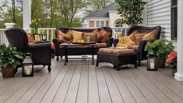 A deck with wicker furniture and lanterns on it