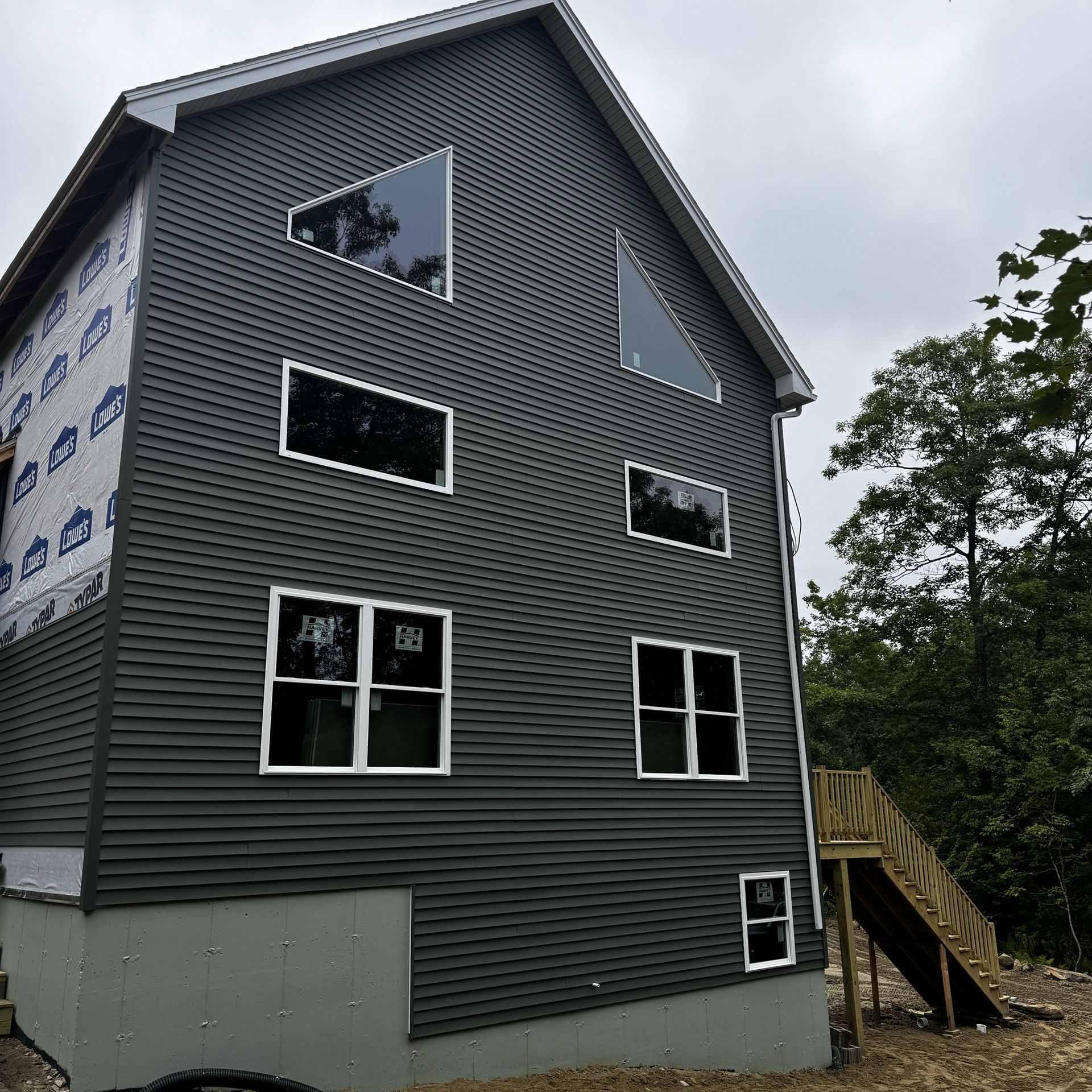 A large house with a lot of windows is being built
