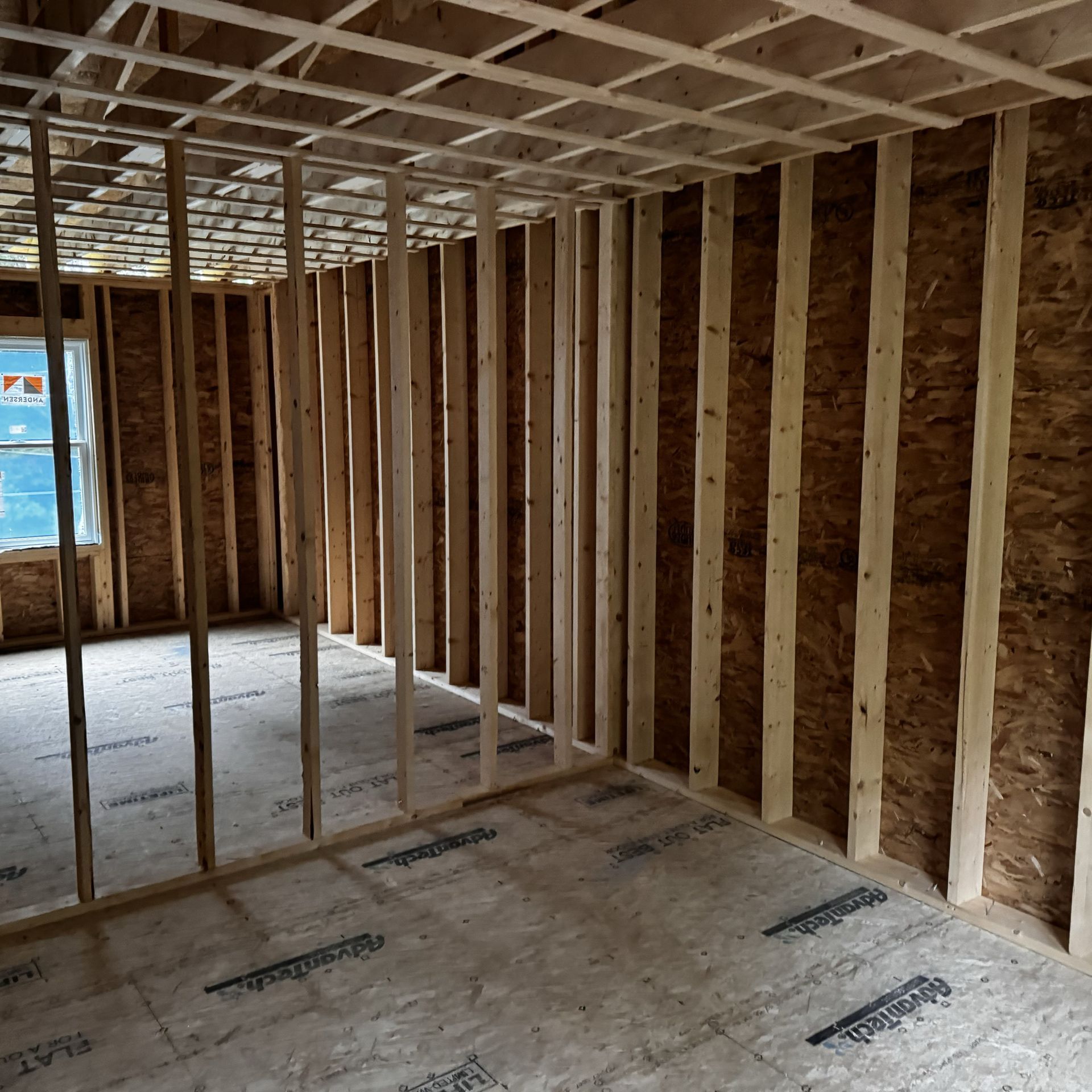 A room with a lot of wooden beams and a window