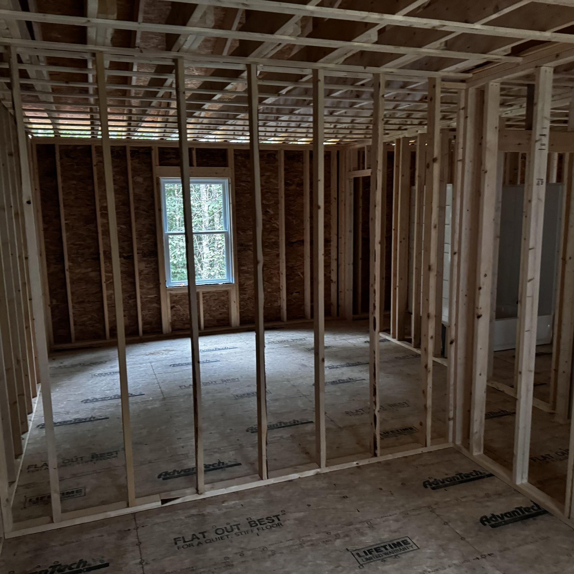 A room in a house under construction with a window