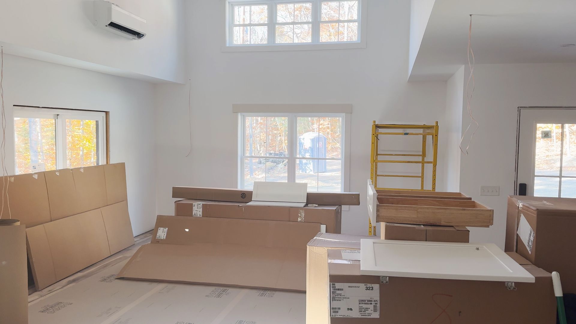 A room with a lot of boxes and a scaffolding in it.