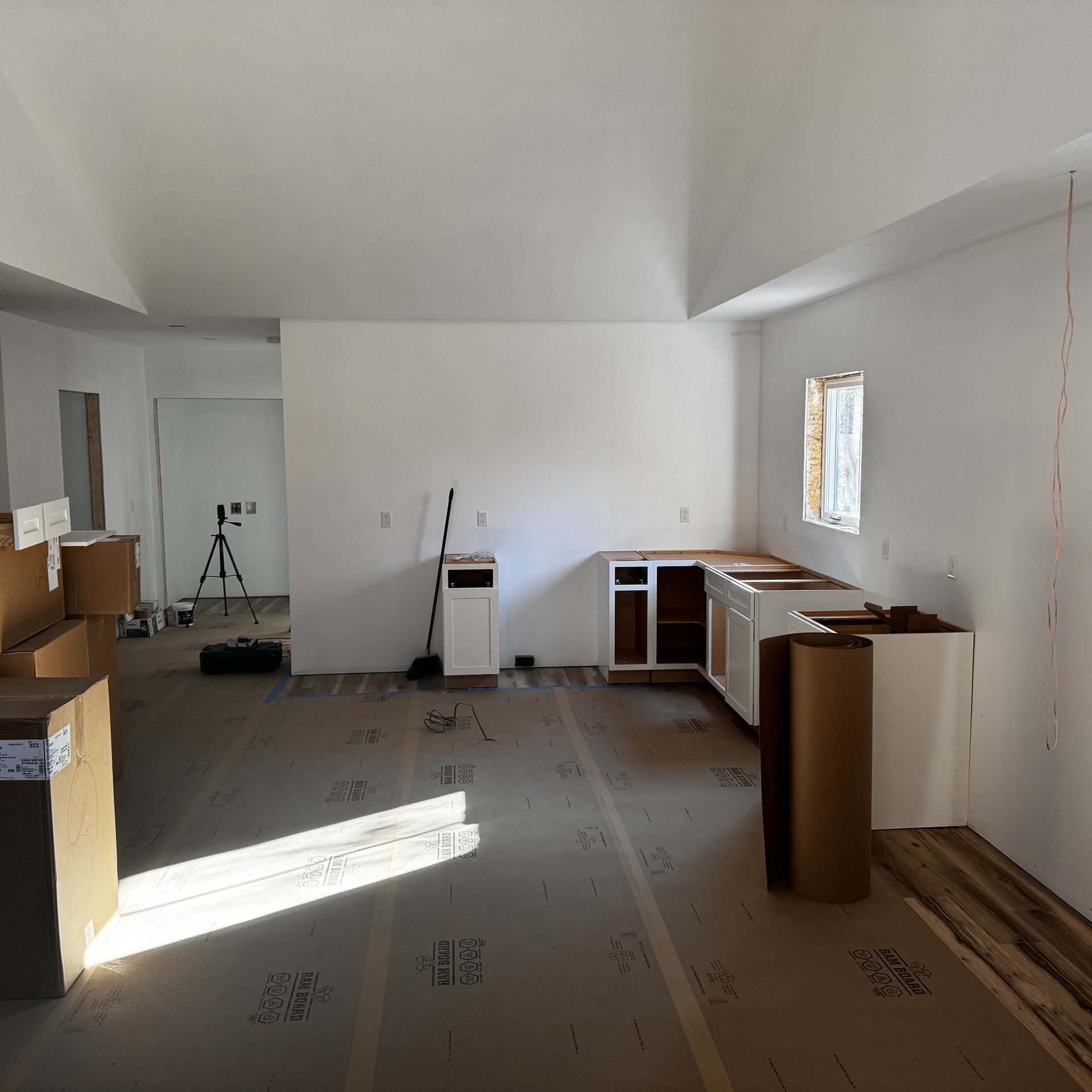 A room with a lot of cardboard boxes on the floor