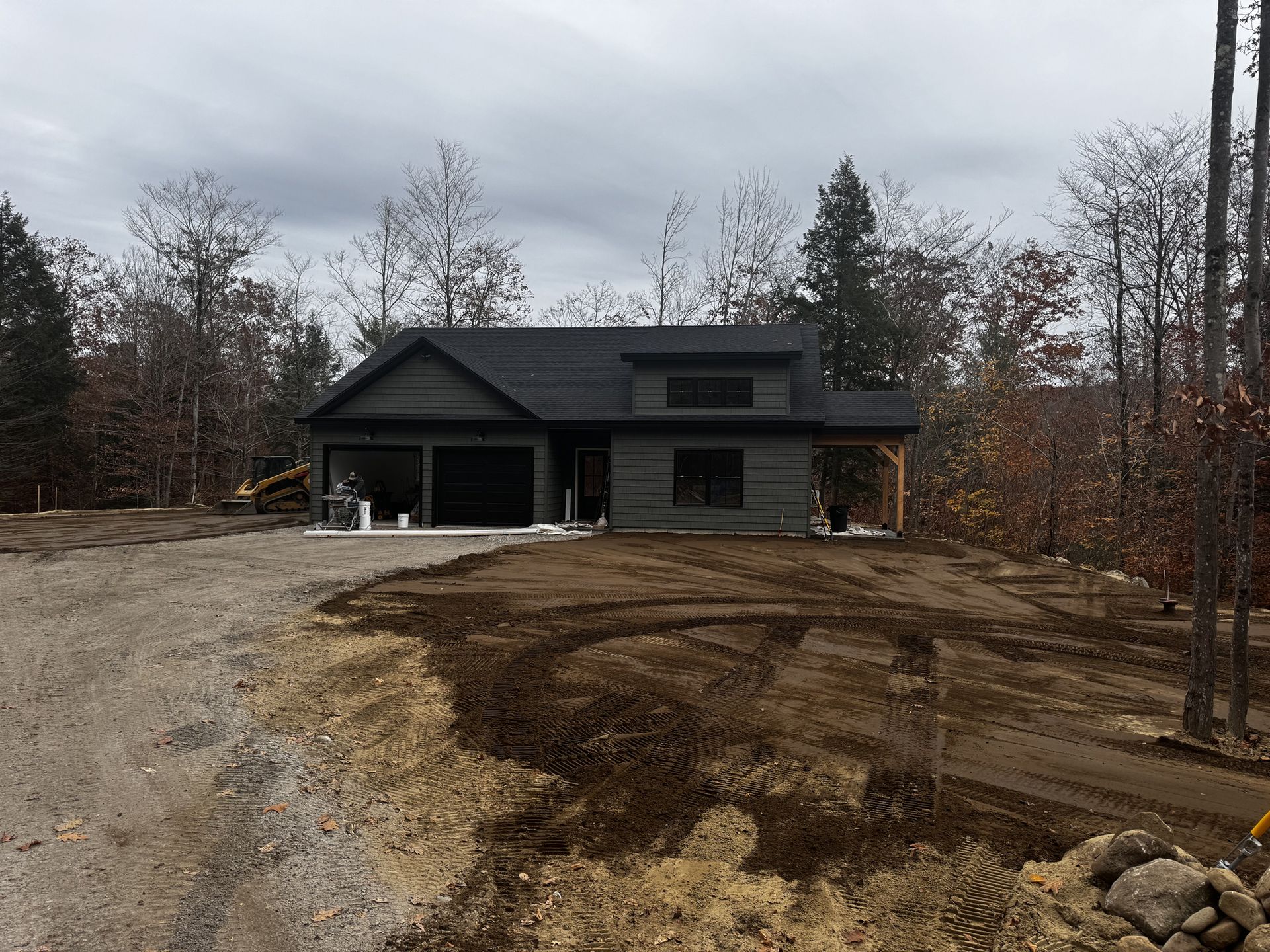 A black house is being built in the middle of a forest.