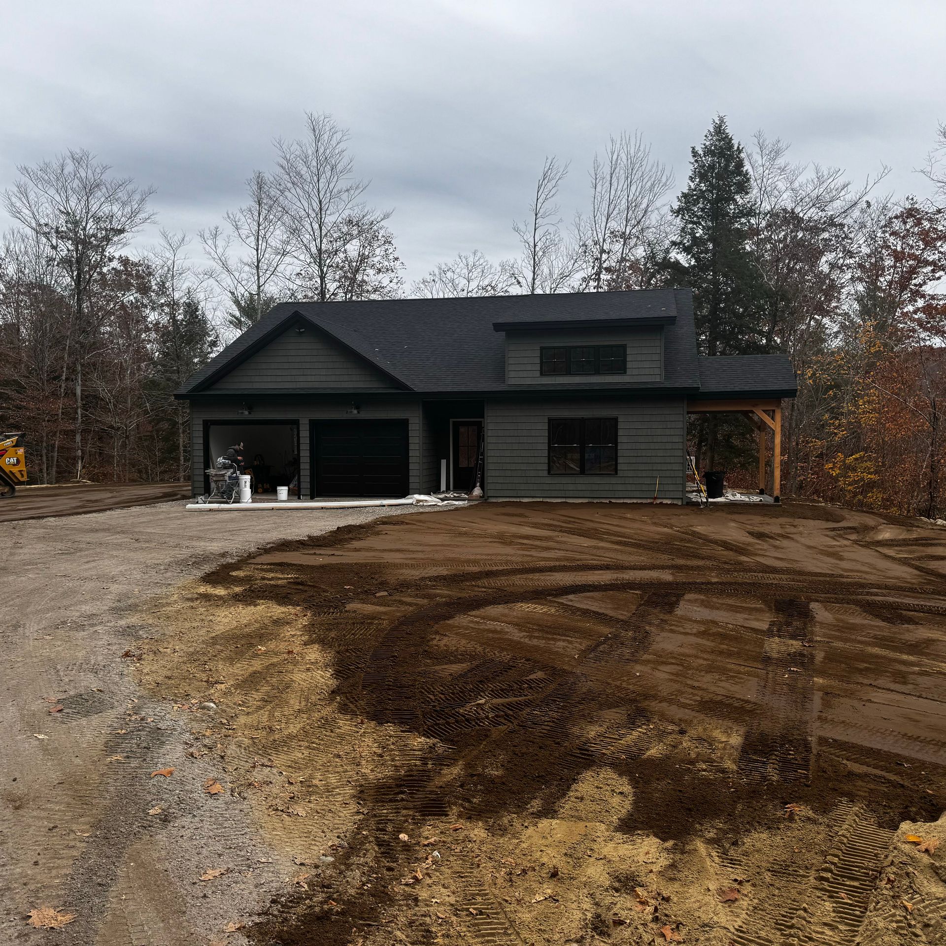 A house is being built in the middle of a dirt field.