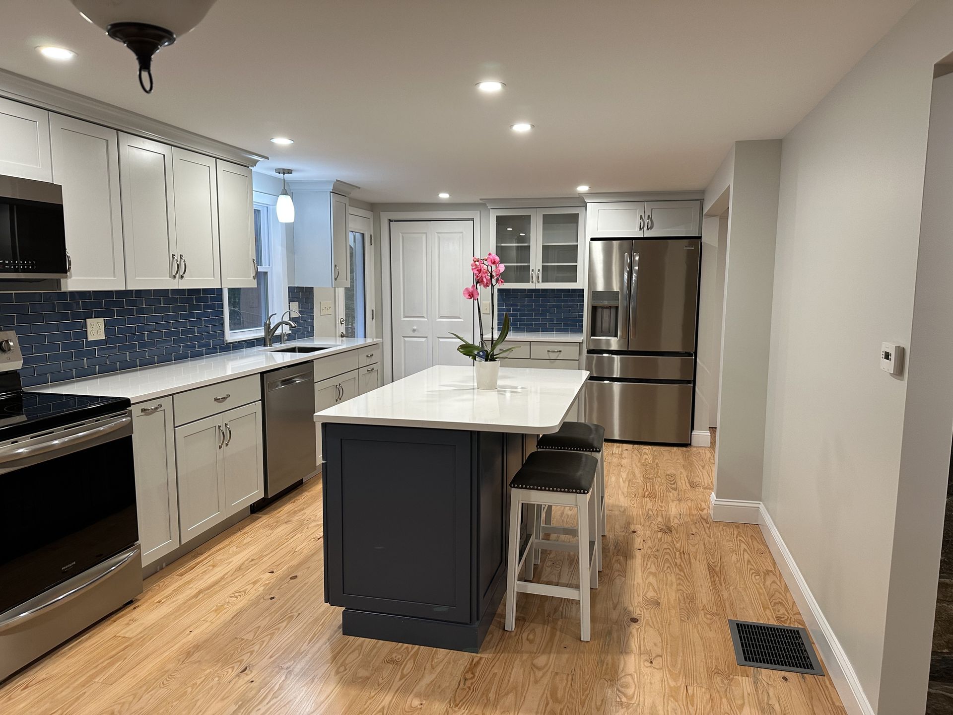 There is a large island in the middle of the kitchen.