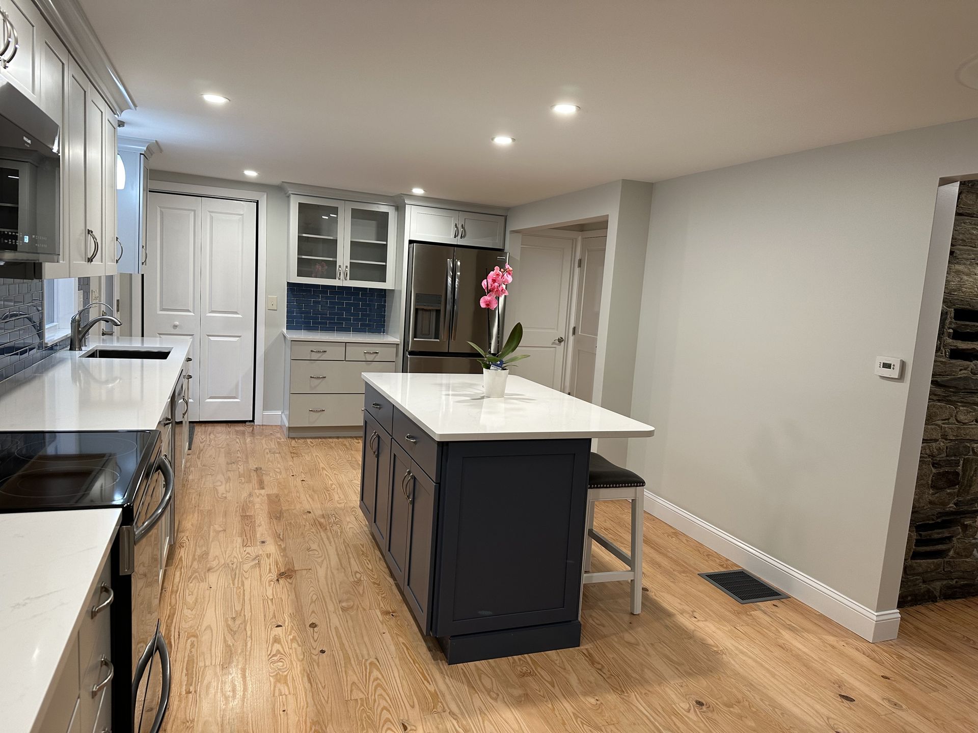 A kitchen with a large island in the middle of it.