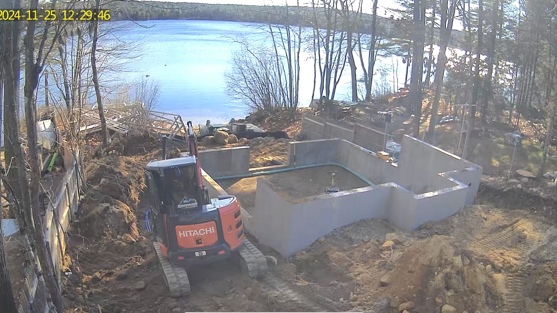A bulldozer is digging in the dirt near a body of water.