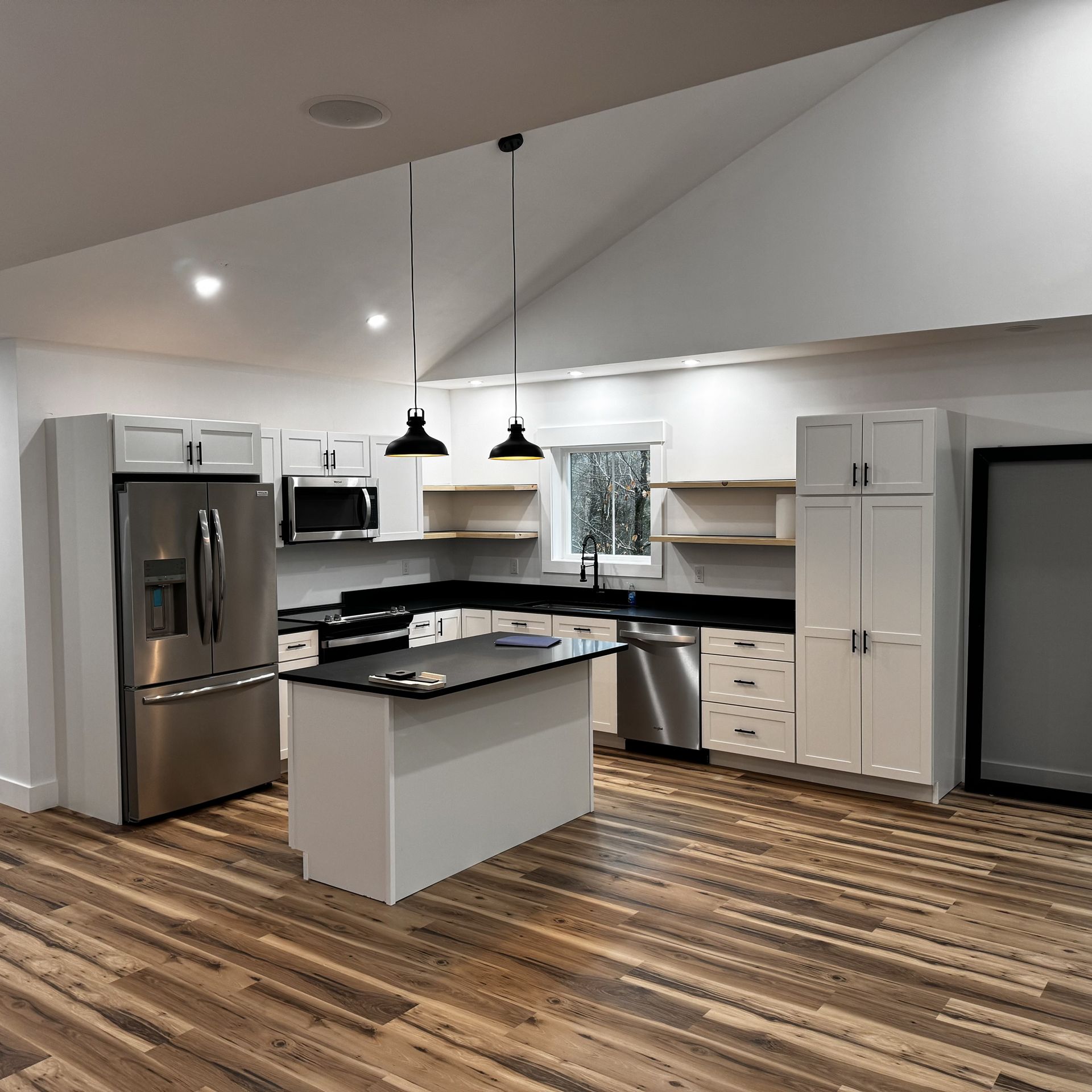 A kitchen with a large island and stainless steel appliances