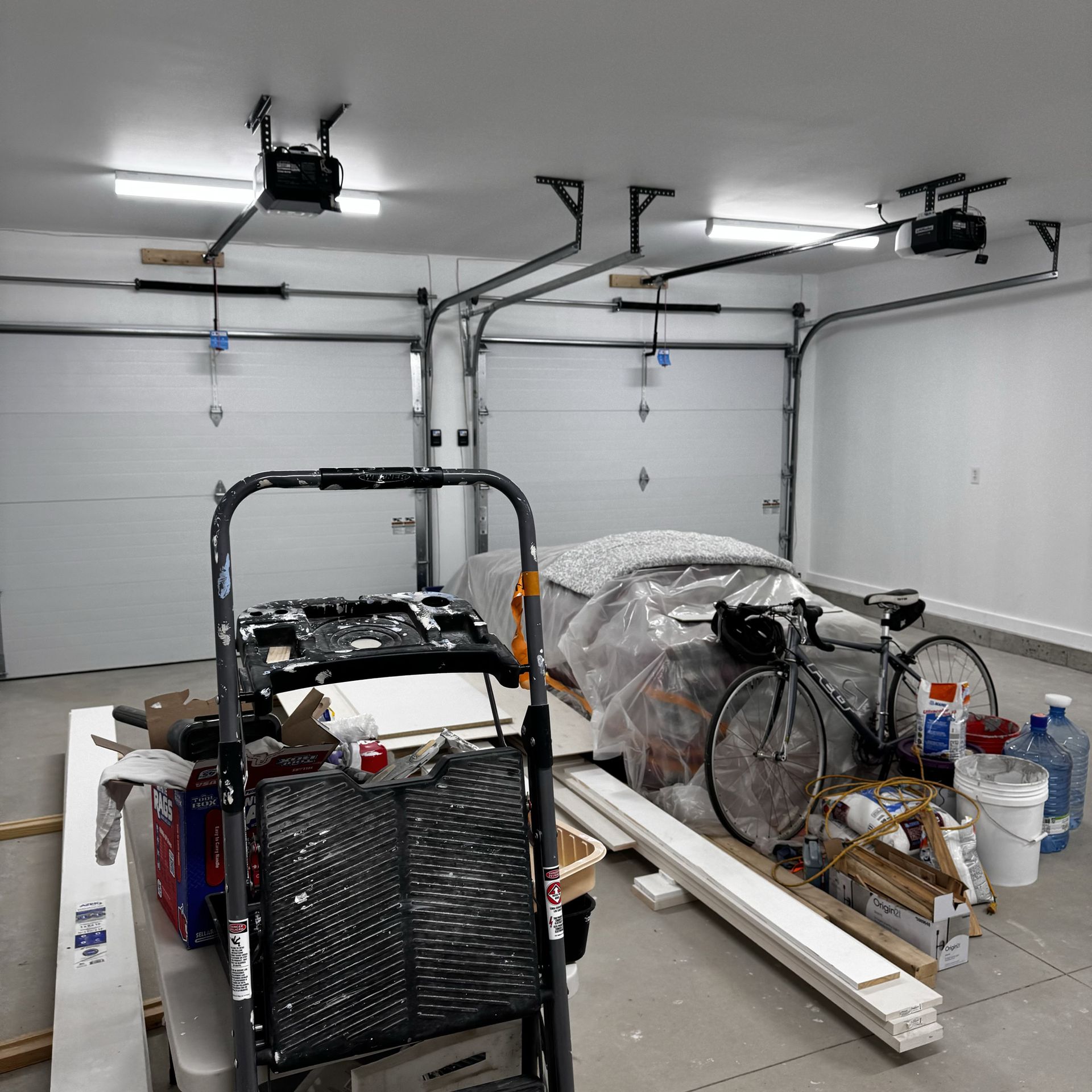 A garage filled with lots of items including a bicycle