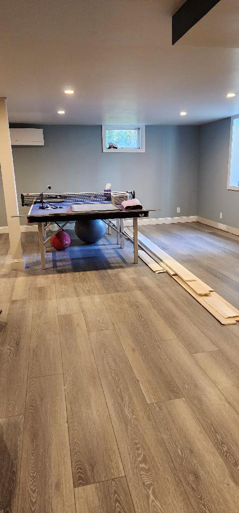 There is a pool table in the middle of the room.