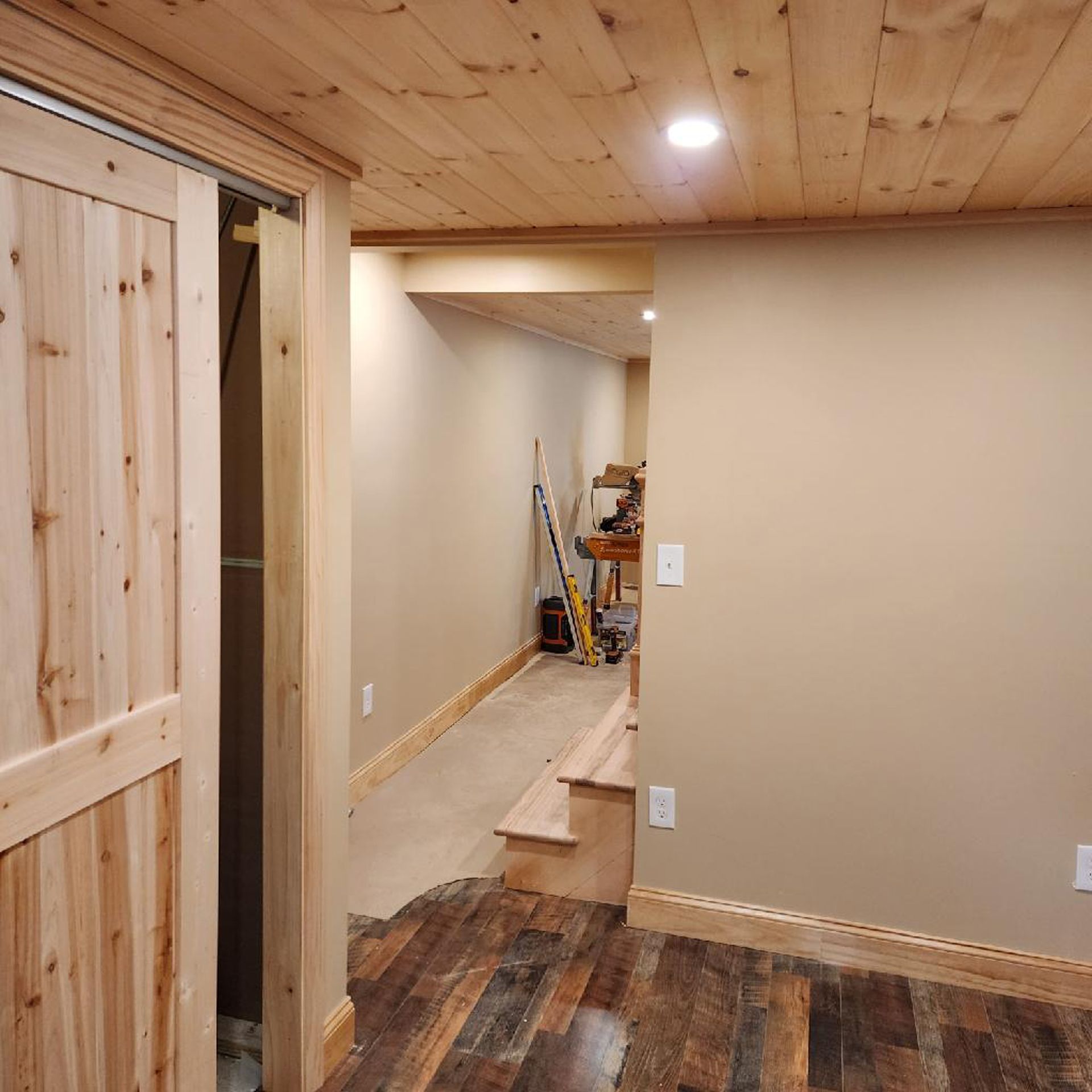 A room with a wooden floor and a wooden door