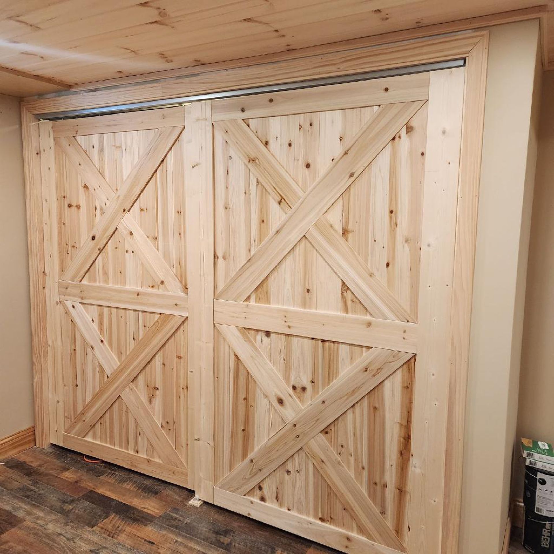 A pair of wooden sliding barn doors in a room.