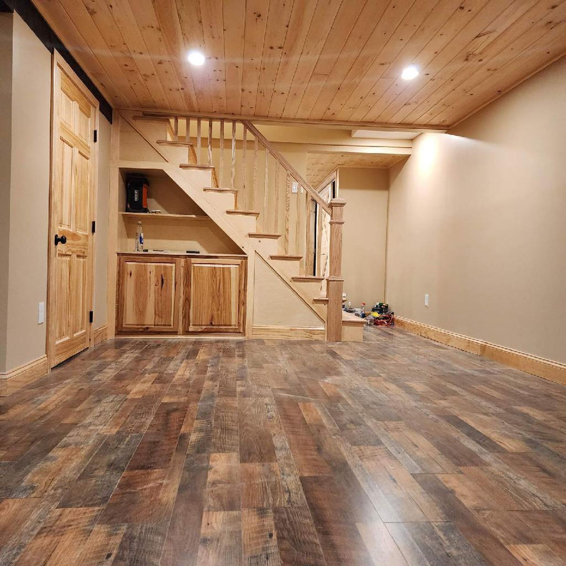 A basement with wooden floors and stairs