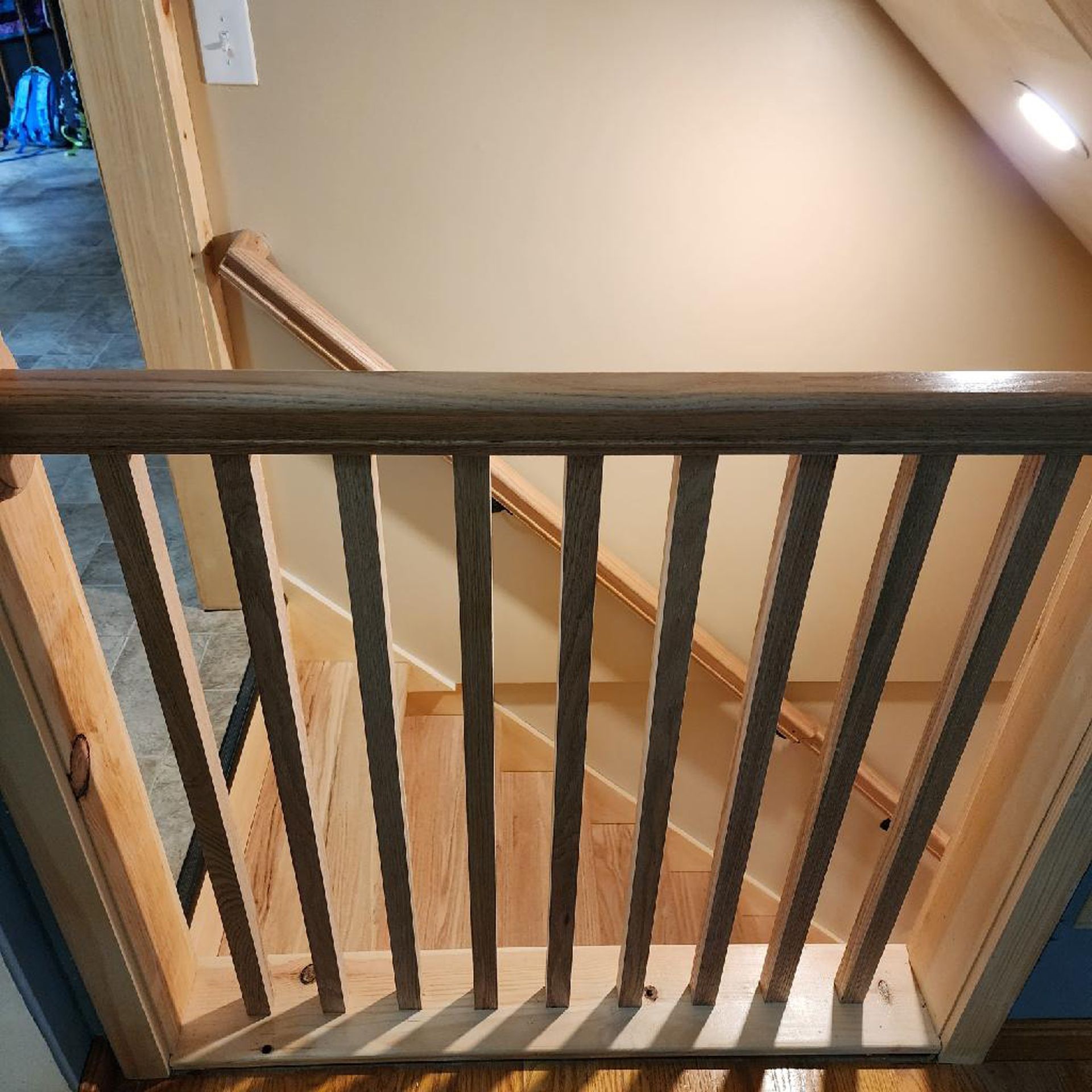 A wooden railing on a set of stairs in a house