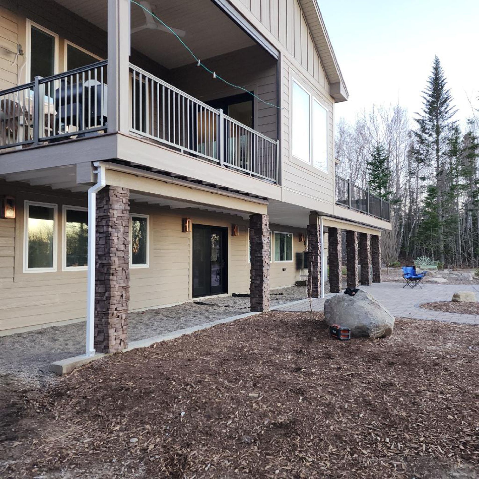 A house with a large rock in front of it