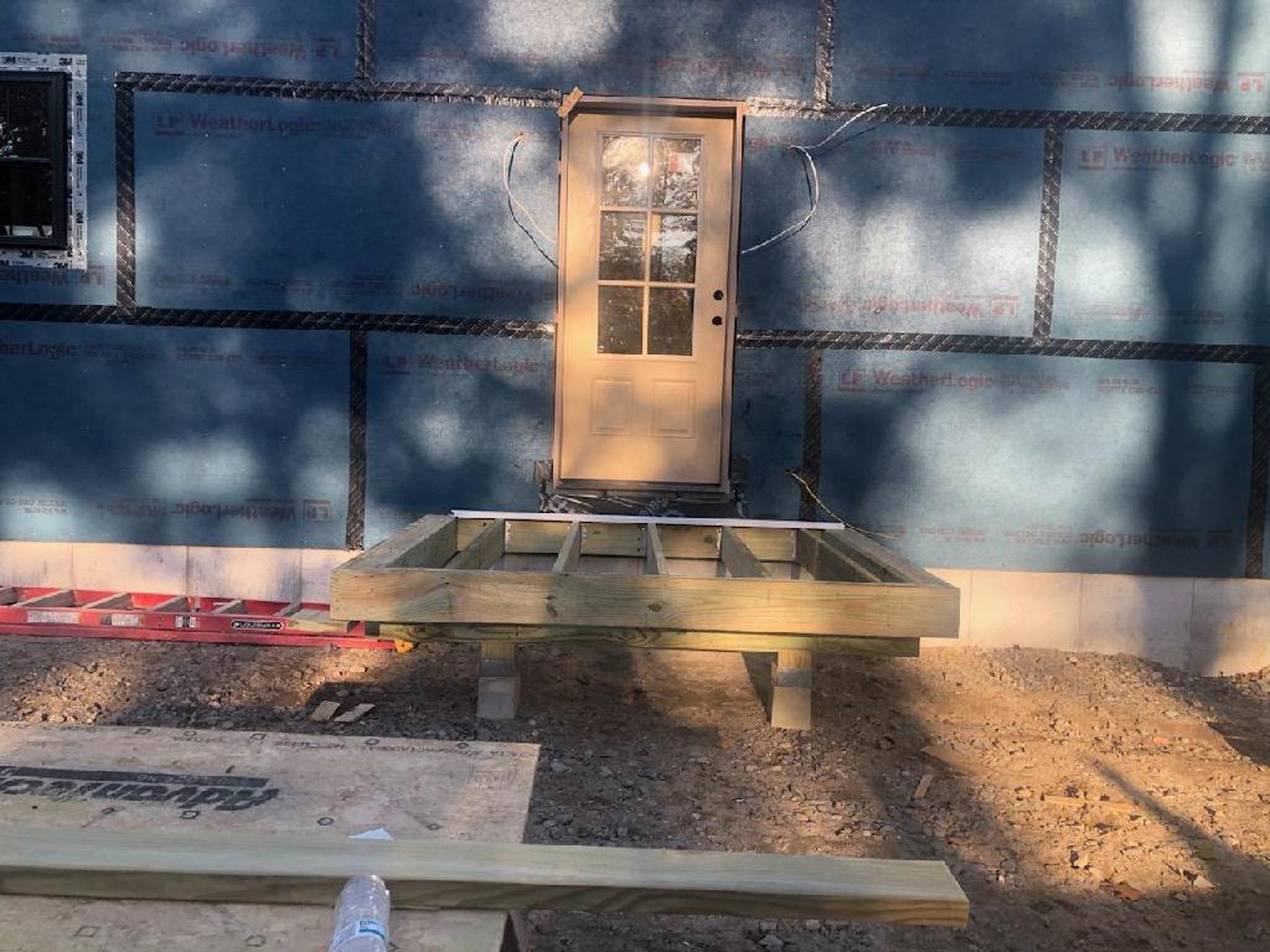 A door is being installed on the side of a building