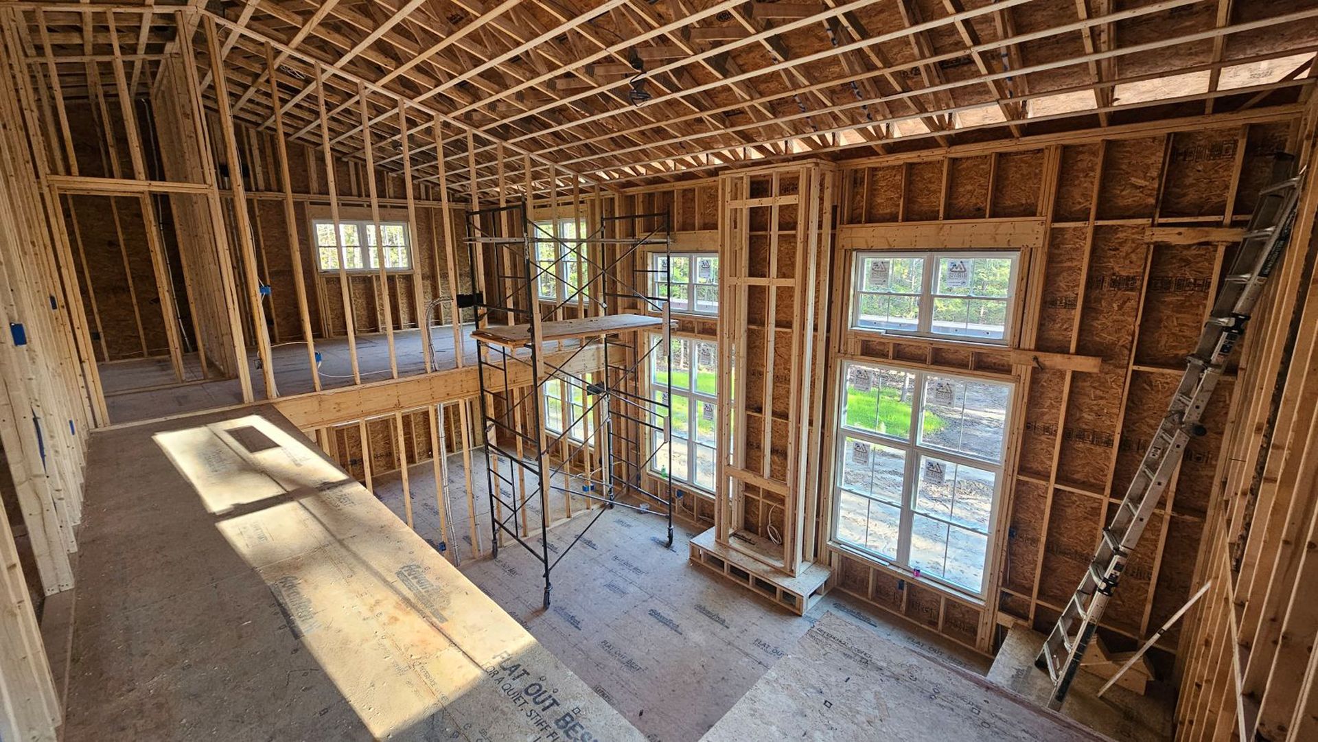 The inside of a house under construction with a lot of windows.