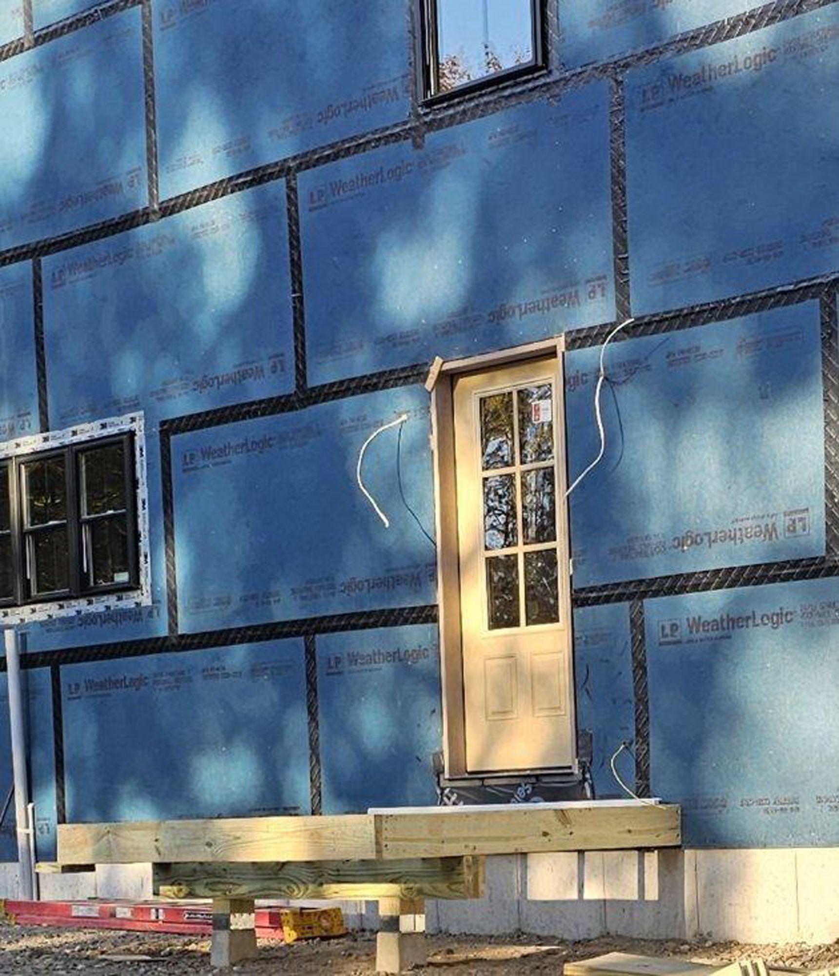A blue wall with a door and windows on it
