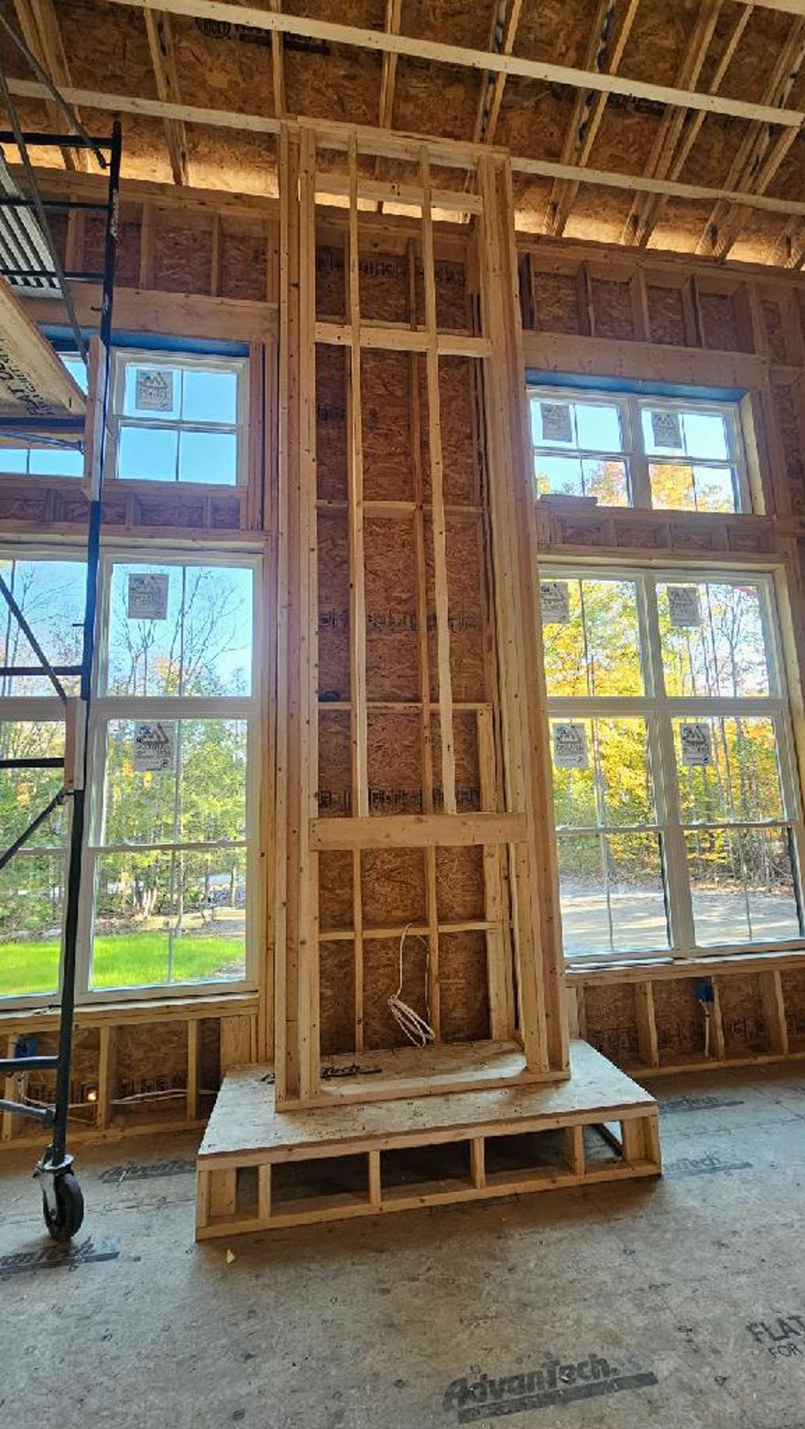 A fireplace is being built in a house under construction.