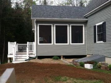 A large white house with a gray metal roof
