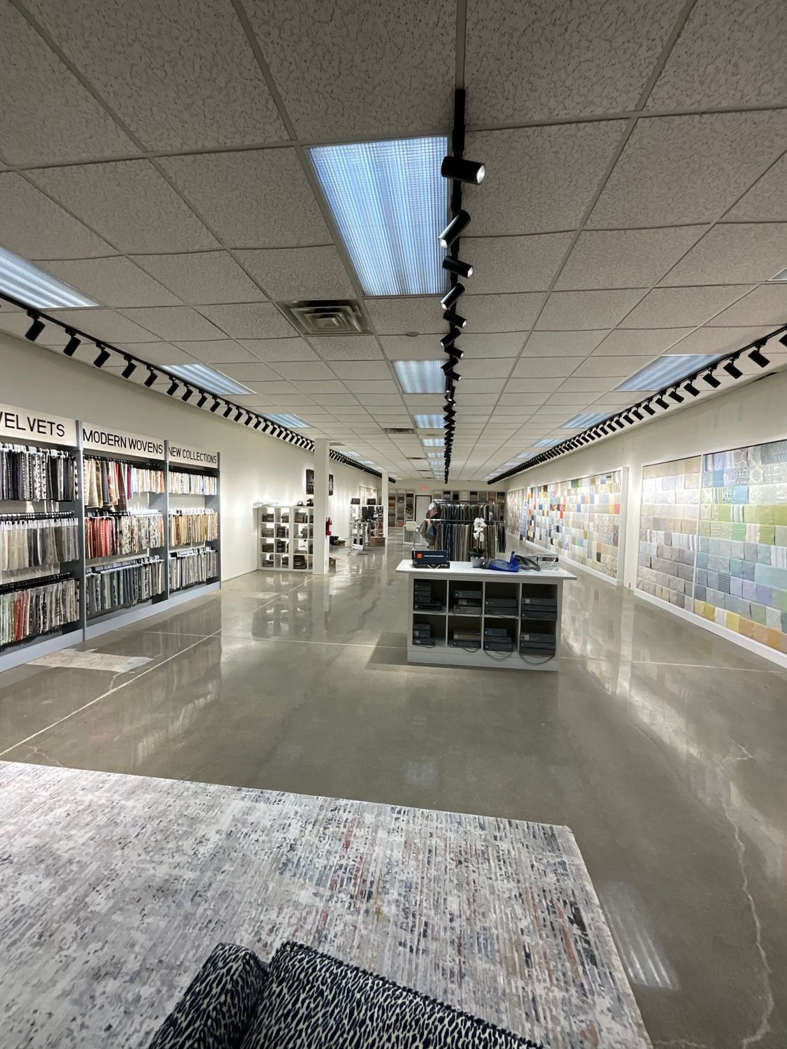 A large room with a lot of shelves and lights on the ceiling.