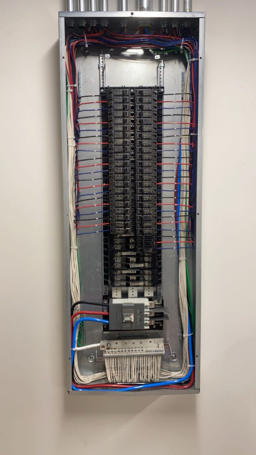 A large electrical box is hanging on a wall.