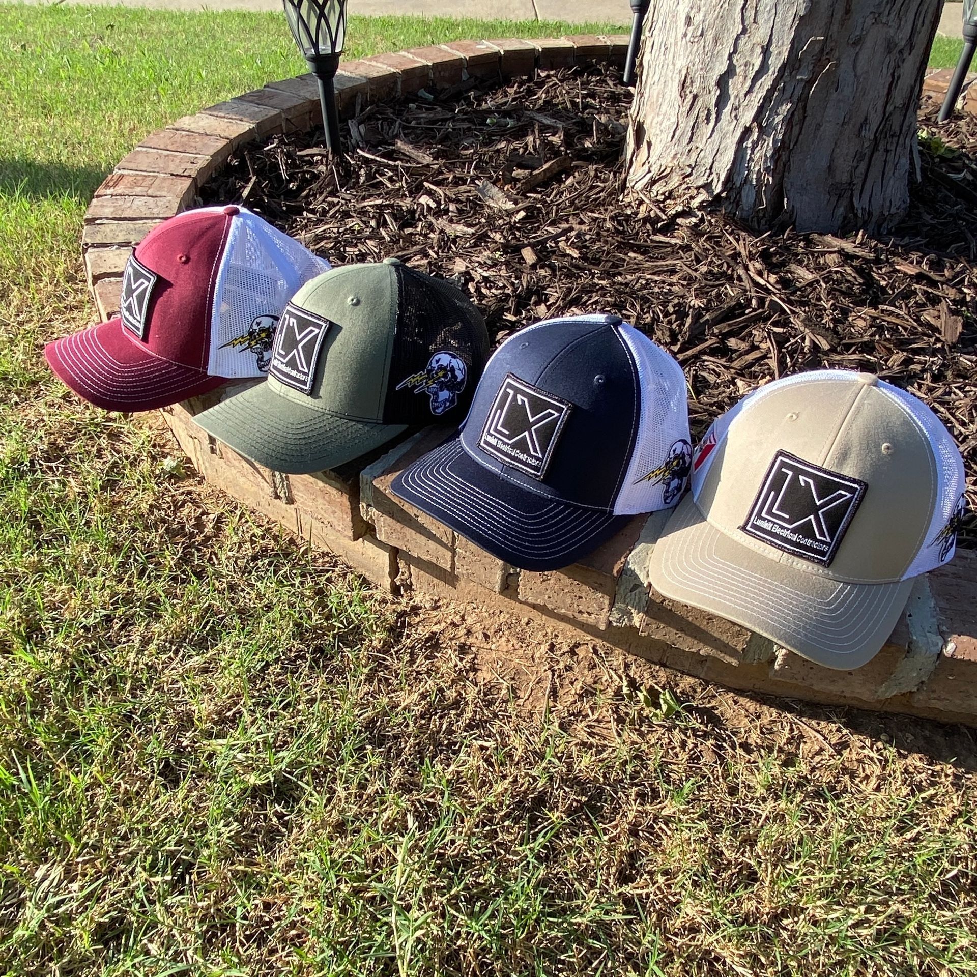 A group of baseball caps are sitting on top of a brick wall.