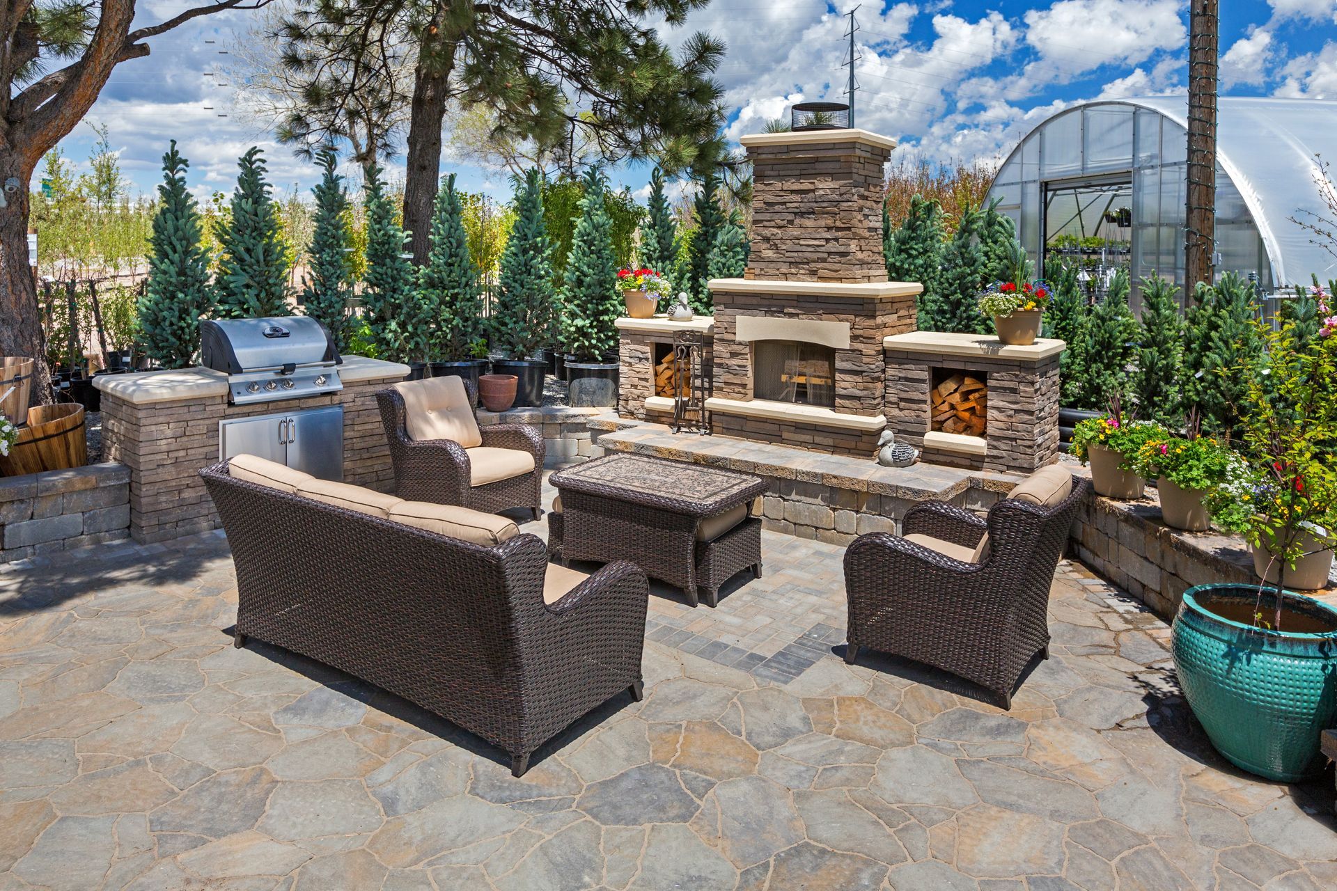 a patio area with wicker furniture and an outdoor fireplace in suffolk county